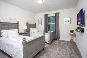 a bedroom with two beds and a window at Marvelous 4 Bd w/ Pool Close to Disney 218 in Kissimmee