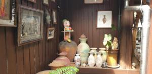 a group of vases on a shelf in a room at Marin' s Home in Thalang