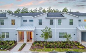 a large white house with a driveway at Marvelous 4 Bd w/ Pool Close to Disney 218 in Kissimmee