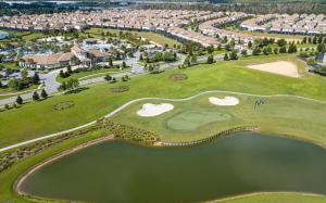 an aerial view of a golf course at a resort at Marvelous 4 Bd w/ Pool Close to Disney 218 in Kissimmee