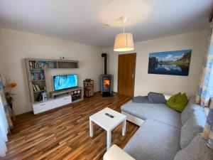 a living room with a couch and a tv at Ferienhaus Bergwelt in Liesing