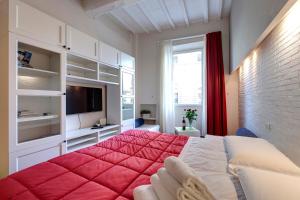 una camera da letto con un grande letto con una coperta rossa di Piazza Signoria View a Firenze