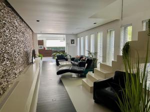 Luxurious villa during tomorrowland في Hemiksem: غرفة معيشة مع كنب وجدار من الطوب