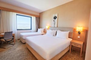 A bed or beds in a room at Park Dedeman Denizli