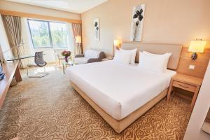 A bed or beds in a room at Park Dedeman Denizli