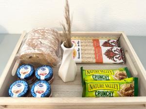 a wooden tray with a box of food and bread at Omma, Main Street suite in Antiparos