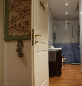 Appartamento blu centro storico في بولونيا: حمام مع حوض ومرحاض وباب