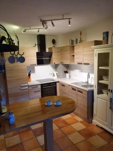 a kitchen with wooden cabinets and a wooden table at Casa-Catalina in Heddesheim