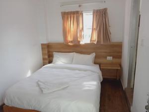 Ένα ή περισσότερα κρεβάτια σε δωμάτιο στο Everest Guest House