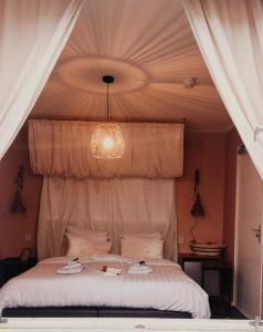 Schlafzimmer mit einem Bett mit Kronleuchter in der Unterkunft Maison Bellefleur B&B - Pension in Renesse