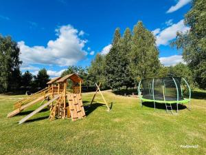 a playground with a slide and a swing at Resort by Nava Lake in Aukštadvaris