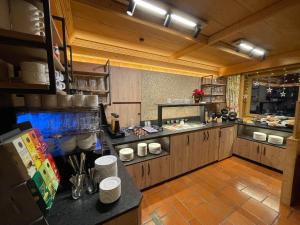 a large kitchen with wooden cabinets and a counter at Ladestatthof in Neustift im Stubaital