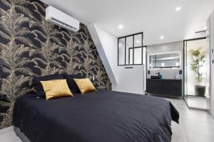um quarto com uma cama preta e almofadas douradas em Double Jeu- NATURISTE VILLAGE-SPA-Clim-2 BEDROOM-Parking-90m2 em Cap d'Agde