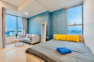 a bedroom with a large bed and a couch at GreenLine Service Aparts - Luxious, Heart of city in Ho Chi Minh City