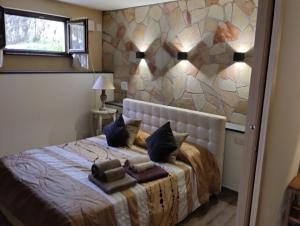 een slaapkamer met een bed met een stenen muur bij Monterosso Pretty Floor in 5 Terre- Cà di Renzo in Pignone