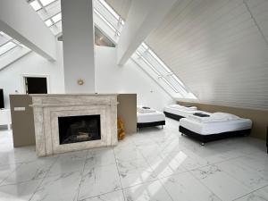 a room with two beds and a fireplace at Big Villa centrally located in Reykjavik in Reykjavík
