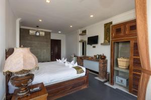 a bedroom with a white bed and a fireplace at The Five Senses Boutique Hotel in Siem Reap