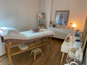 a small room with a bed and a table at Hôtel SPA Le Tosny in Épaignes