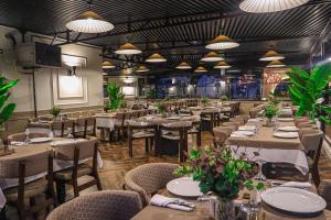 a dining room with tables and chairs and lights at Black Bird Thermal Hotel & SPA in Gokcedere