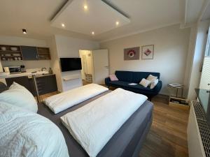 a living room with two beds and a couch at Saarland Appartements in Wadgassen