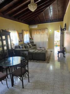 a living room with a couch and a table at Seaview Villa in St Mary