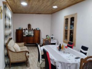 a dining room with a white table and chairs at Spardishi tower in Mestia