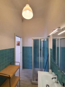 a bathroom with a shower and a sink and a table at Casa del Golfo in Riccò del Golfo di Spezia