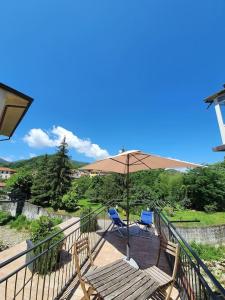 a patio with two chairs and an umbrella at Casa del Golfo in Riccò del Golfo di Spezia