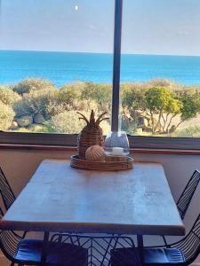 a table with a view of the ocean from a window at Agde : Appartement 2 chambres au bord des falaises in Cap d'Agde