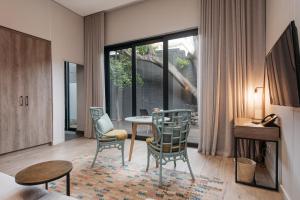 a living room with a table and chairs at The Tree House Boutique Hotel by The Living Journey Collection in Cape Town