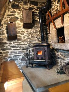 a stone wall with a wood stove in a room at Casa do Grallo in Corcoesto +52 photos