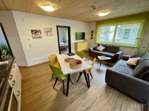 a living room with a couch and a table at Alpenapart Singer - contactless check-in in Reutte