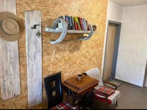 a room with a table and a shelf with books at Apartmány Skala in Příbram