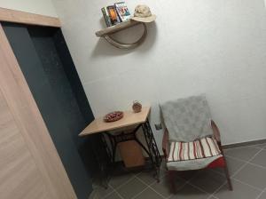a table and a chair next to a table and a hat at Apartmány Skala in Příbram