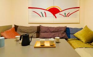 a coffee table in a living room with a couch at Love Asakusa 1 Bedroom Apartment Sleeps 6 SkyTree View 3 Min to Sensoji Airport Direct Elevator Free WiFi in Tokyo +32 photos