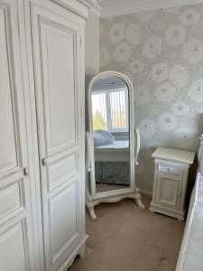 a bedroom with a mirror and a bed in it at Cosy 3-bed house in Hull