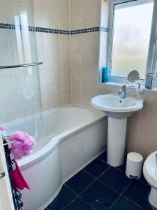 a bathroom with a sink and a tub and a toilet at Cosy 3-bed house in Hull