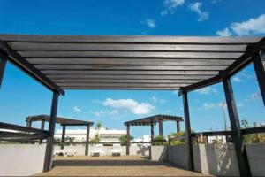 a pavilion with tables and chairs on a patio at Appartement T2 en bord de mer in Roquebrune-Cap-Martin