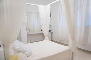 Postel nebo postele na pokoji v ubytování Hostal Mamà Mambò - Zona Colonial