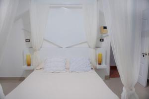 Postel nebo postele na pokoji v ubytování Hostal Mamà Mambò - Zona Colonial