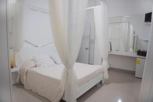 Postel nebo postele na pokoji v ubytování Hostal Mamà Mambò - Zona Colonial