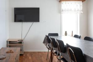 a conference room with a table and chairs and a flat screen tv at The Holiday Houses in Kirkjubæjarklaustur
