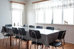 a conference room with a large table and chairs at The Holiday Houses by Stay Iceland in Kirkjubæjarklaustur