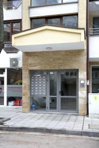 a building with a large glass door on a street at Детелина in Ruse