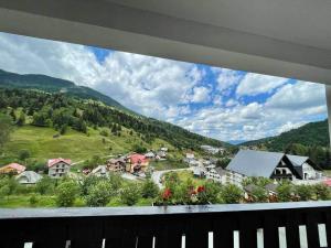 a view from a balcony of a small town with houses at PIZZERIA RUSTICA cazare in Borşa