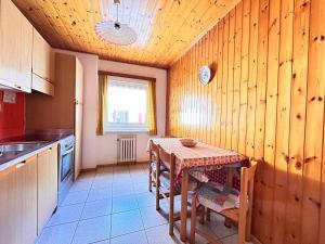 a kitchen with a table and a table and a window at Apartment Nido in Selva di Val Gardena