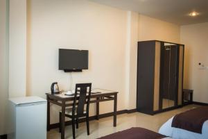 a room with a desk with a phone and a television at Centerpoint Boutique Hotel in Vientiane +7 photos