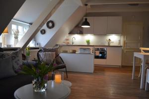 a living room and kitchen with a couch and a table at Deichhof - Whg3 in Dunsum