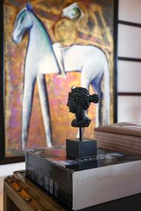 a statue on a table with a painting of a horse at Savoy Hotel & Spa - Preferred Hotels & Resorts in Paestum