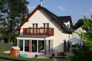 a house with a balcony on top of it at BnB "Les Coquelicots" in Mies